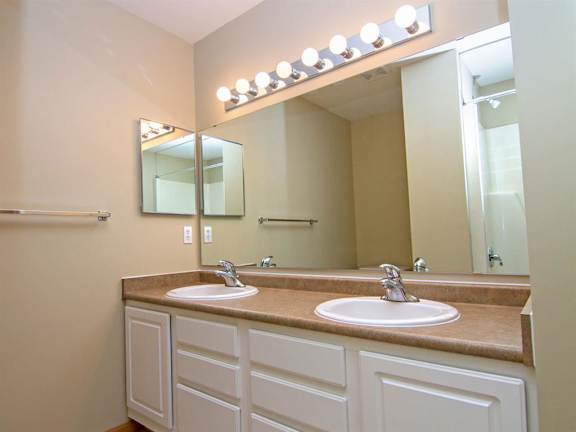 Master Bathroom with dual sinks and white cabinetry at Cascade Pines Duplex Homes in Lincoln NE