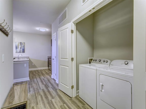 a laundry room with a washer and dryer and a sink