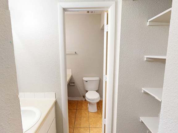A white bathroom with a toilet and a bathtub.
