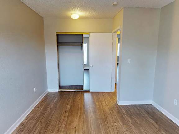 A room with a white door and a window.