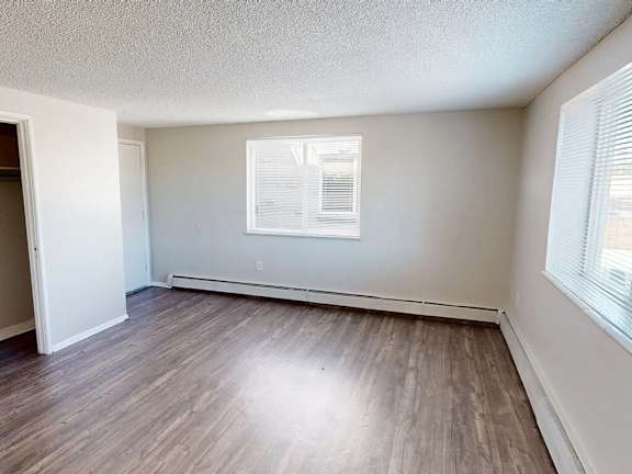 A room with a window and a door.