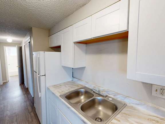 A kitchen with a sink and cabinets.