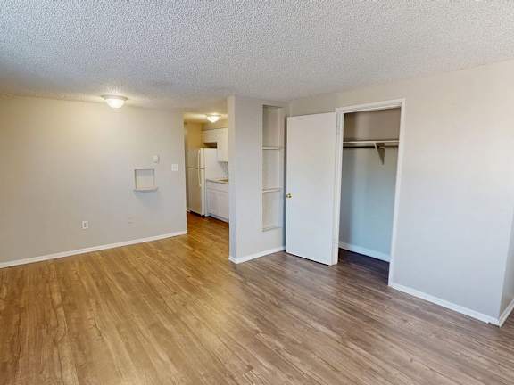 A room with a white door and a white wall.