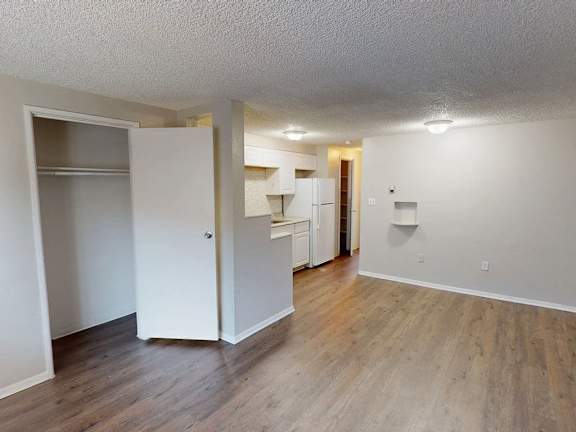 A room with a white door and a white wall.