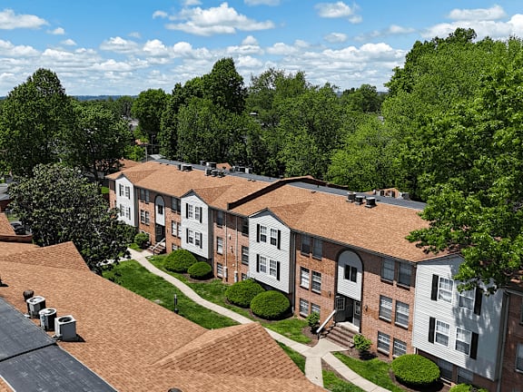 Apartment complex with a green tree in front.