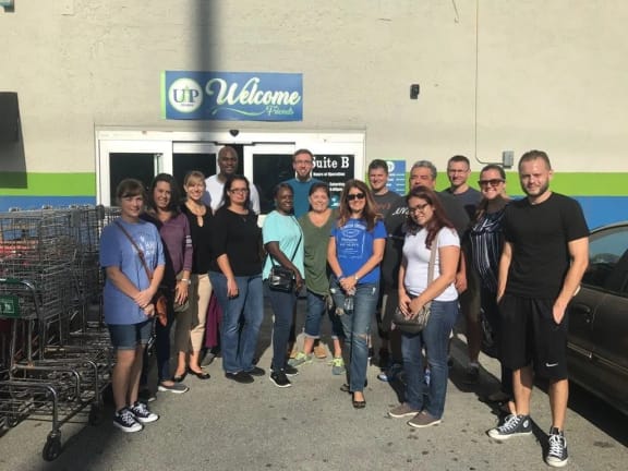 a group of people posing for a picture in front of a walgreens store