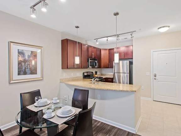 A kitchen with a table set for two.