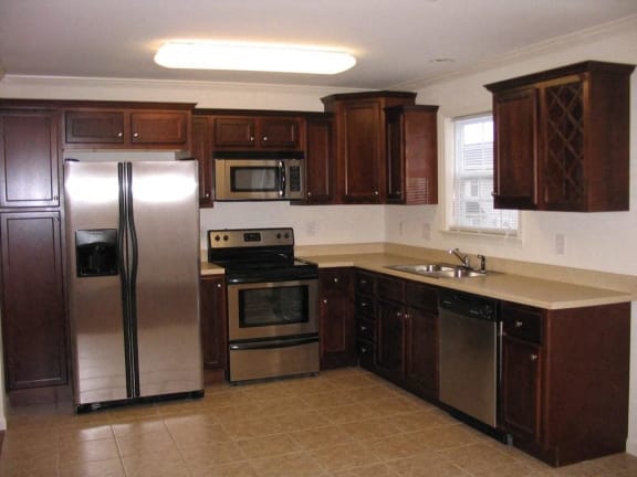 a kitchen with stainless steel appliances and wooden cabinets