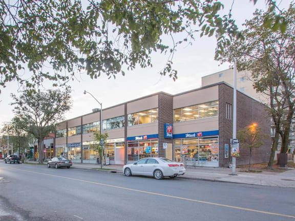 A car is parked in front of a 7-Eleven store.