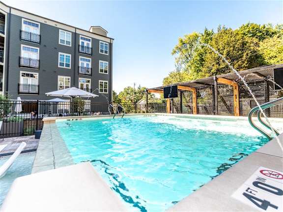 A swimming pool in front of a building with a height of 47 feet at The Foundry Apartments , South Bend, IN, 46617