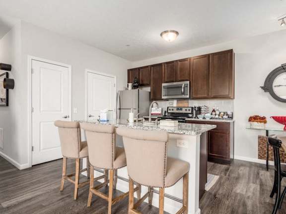 a kitchen and dining room with a table and chairs