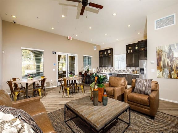Club room with tables and kitchen with a refrigerator