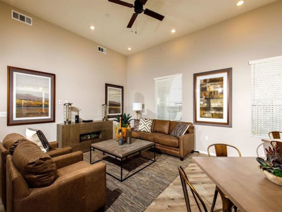 Furnished clubroom with love seat sofa, coffee table, frames, dining table