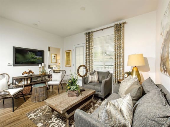 Open floor plan with spacious living room and white kitchen cabinets
