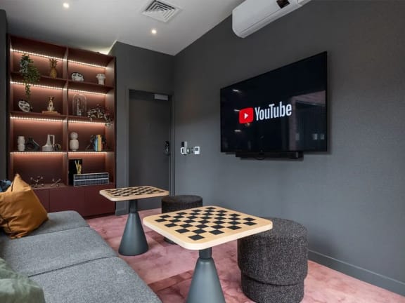 a game room with a checkered board and a television