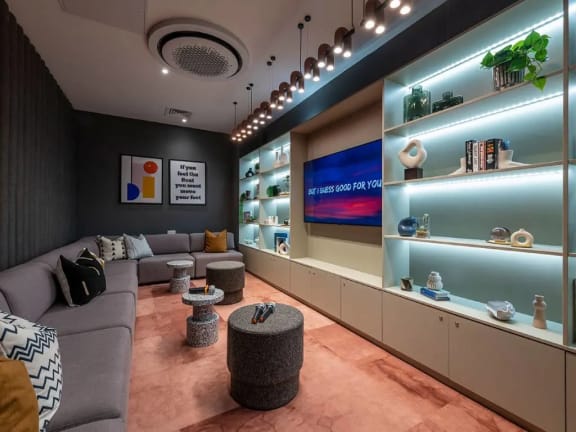 a living room filled with furniture and a display case