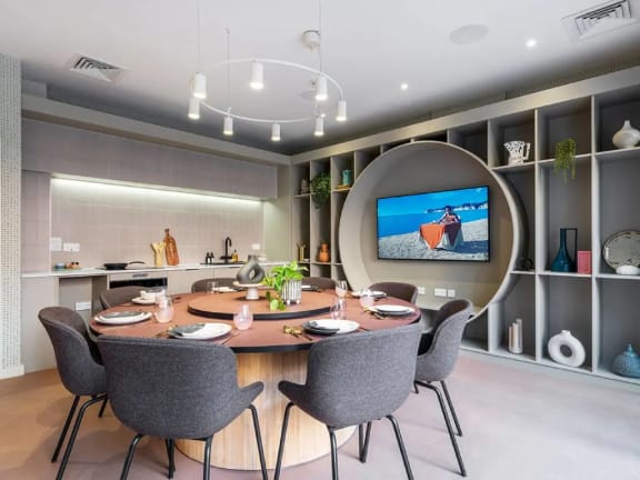 a dining room with a table and chairs and a tv