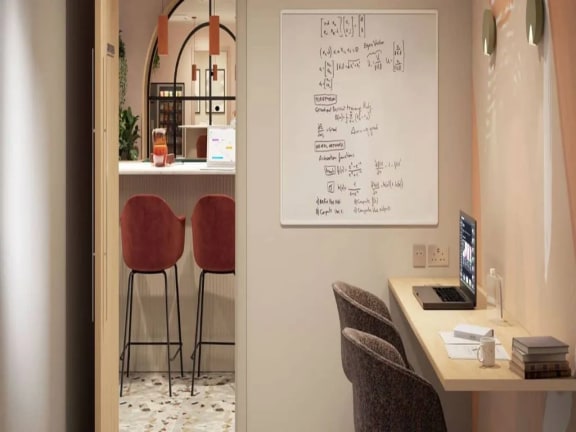 a office with a desk and a table with chairs