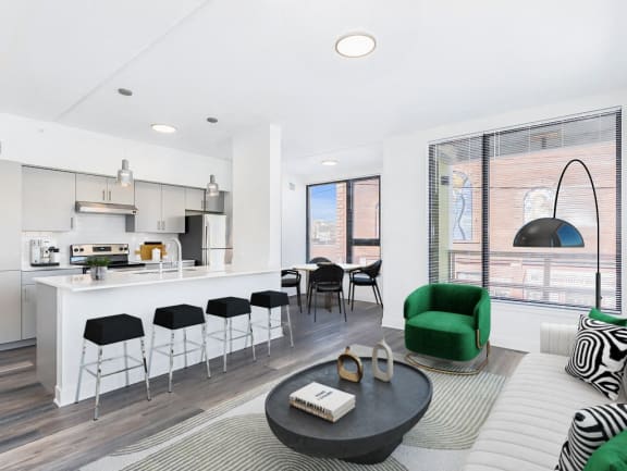 a living area with a kitchen and a couch and a table