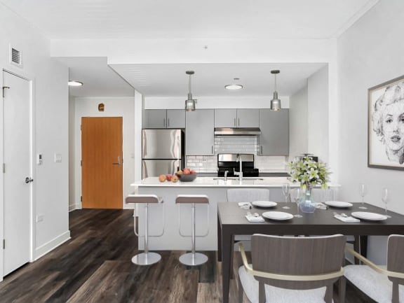 a kitchen and dining room with a table and chairs