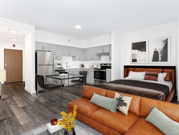 a living room and kitchen with a couch and a table