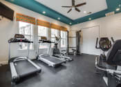 Thumbnail 20 of 27 - Fitness center with refreshing pool views at CLEAR Property Management , The Lookout at Comanche Hill, Texas
