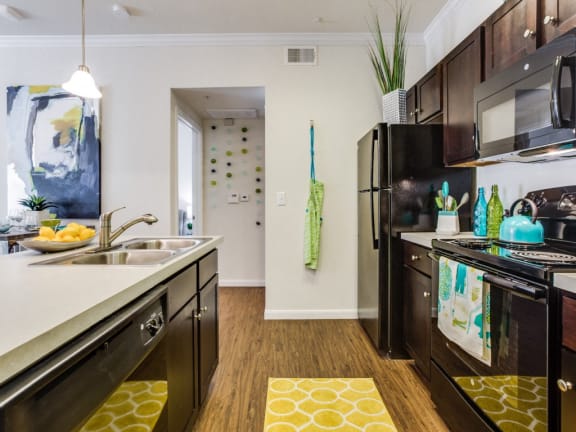 Shaker-style mocha cabinetry with brushed nickel hardware at CLEAR Property Management , The Lookout at Comanche Hill, Texas, 78247