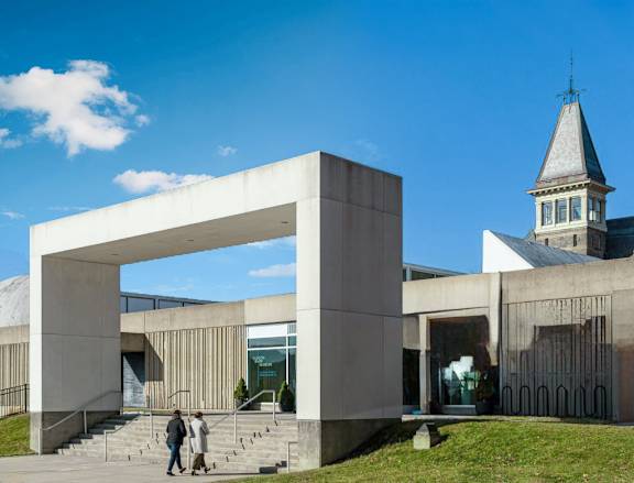 a large concrete building with a steeple in the background