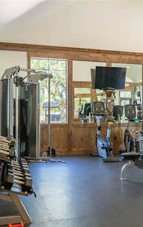 A fitness center with a variety of exercise equipment at Riverplace Apartment Homes, Oregon, 97351