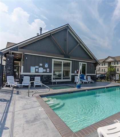 A pool area with apartments in the background at Sandyplace Apartment Homes, Sandy, OR, 97055