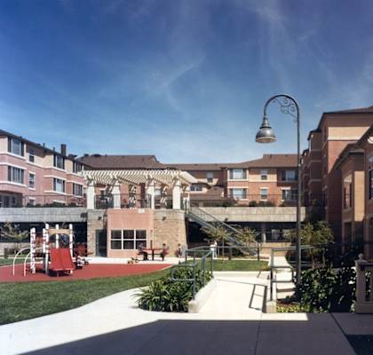 an exterior view of an apartment complex with a playground