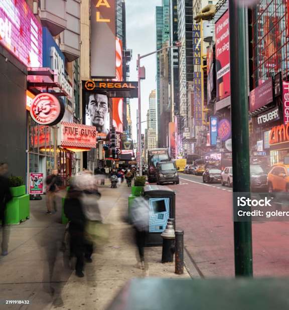 A busy city street with people walking and biking.