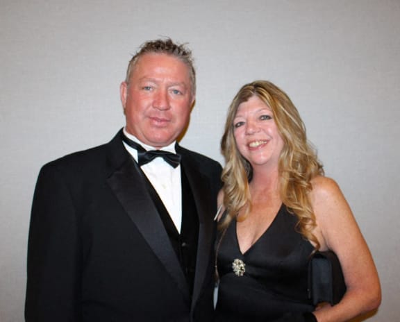 a man in a tuxedo and a woman in a black dress