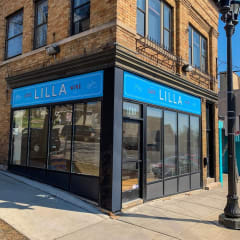 a building with a blue sign that says lula wine