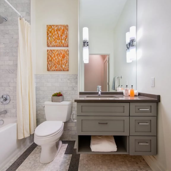 a bathroom with a toilet and a sink and a mirror