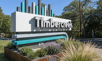 A Timbercreek sign is displayed on a white building with a green border.