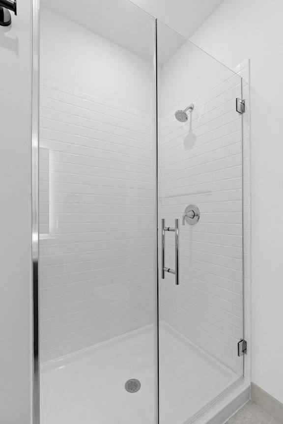 a bathroom with a shower and a glass door at The Mera, Minnesota, 55426