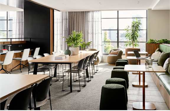 A modern dining area with a long table and chairs.