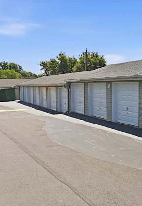 A long row of garage doors are closed.