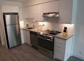Thumbnail 29 of 37 - Renovated Kitchen with Stainless Steel Appliances and White Cabinets