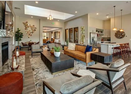A modern living room with a fireplace and a large sofa.