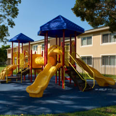 a childrens playground in front of an apartment building