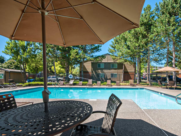 Hunt Club apartments pool and pool deck with tables and umbrellas