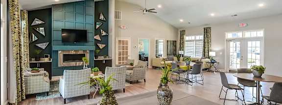 A living room with a grey coffee table and a pineapple vase on it.