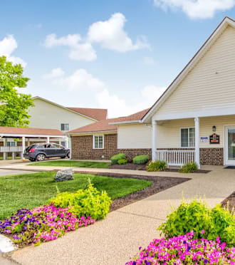 a white house with a driveway and a garage door