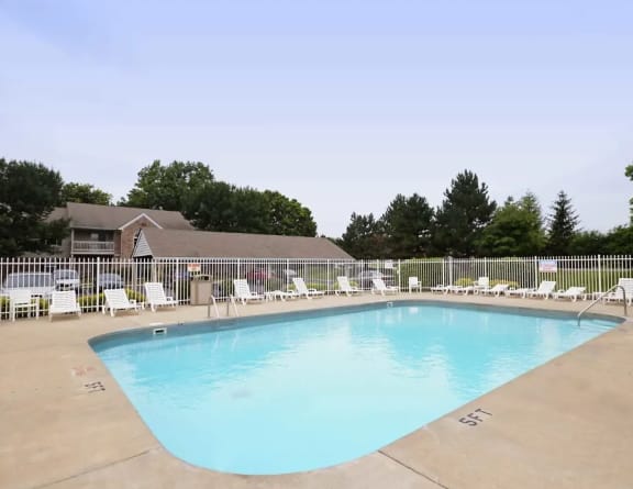 our resort style swimming pool is next to our building with lounge chairs