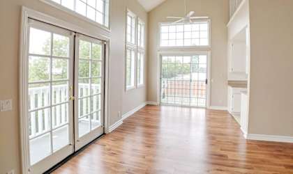 A room with wooden floors and a ceiling fan.