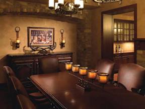 A dining room with a long table and chairs.
