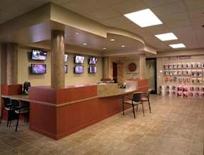 A reception area with a counter and chairs.