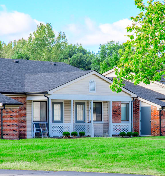 A house with a grey front porch and a white door.